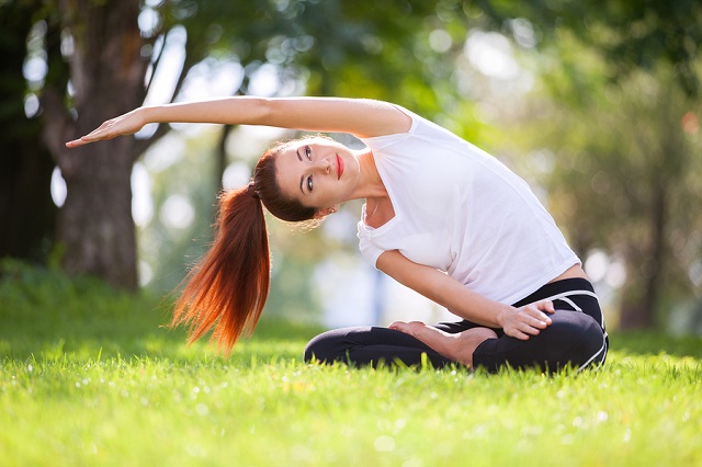 bigstock Yoga outdoor Happy woman doin 172357403