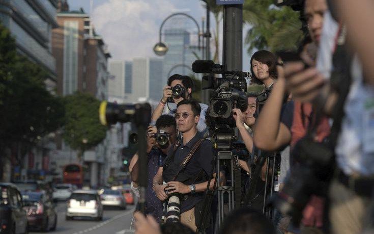 Journalists wait for North Korean leader Kim Jong Un outside the Istana, or Presidential Palace, in Singapore, Sunday, June 10, 2018, Kim met with Singapore Prime Minister Lee Hsien Loong ahead of the summit with U.S. leader Donald Trump. (AP Photo/Joseph Nair)