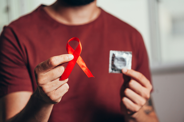 bigstock Man Holding Condom And Red Rib 331649992