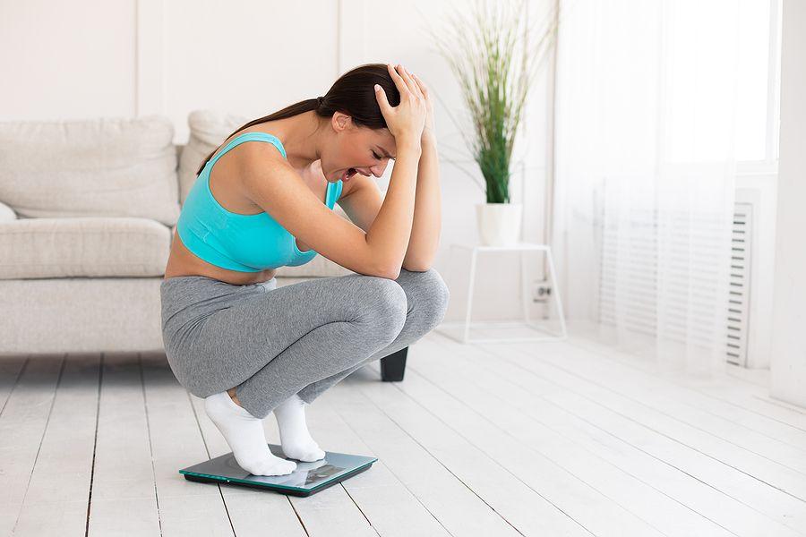 Weight Gain. Unhappy Woman Crying Standing On Weight-scales Not Losing Weight On Diet Slimming At Ho