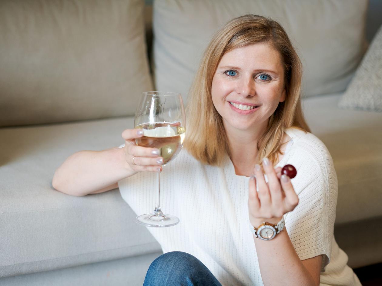 Portrait Beautiful And Charming, Attractive Connoisseur Woman, Sitting On Floor By Sofa, Raising Gla