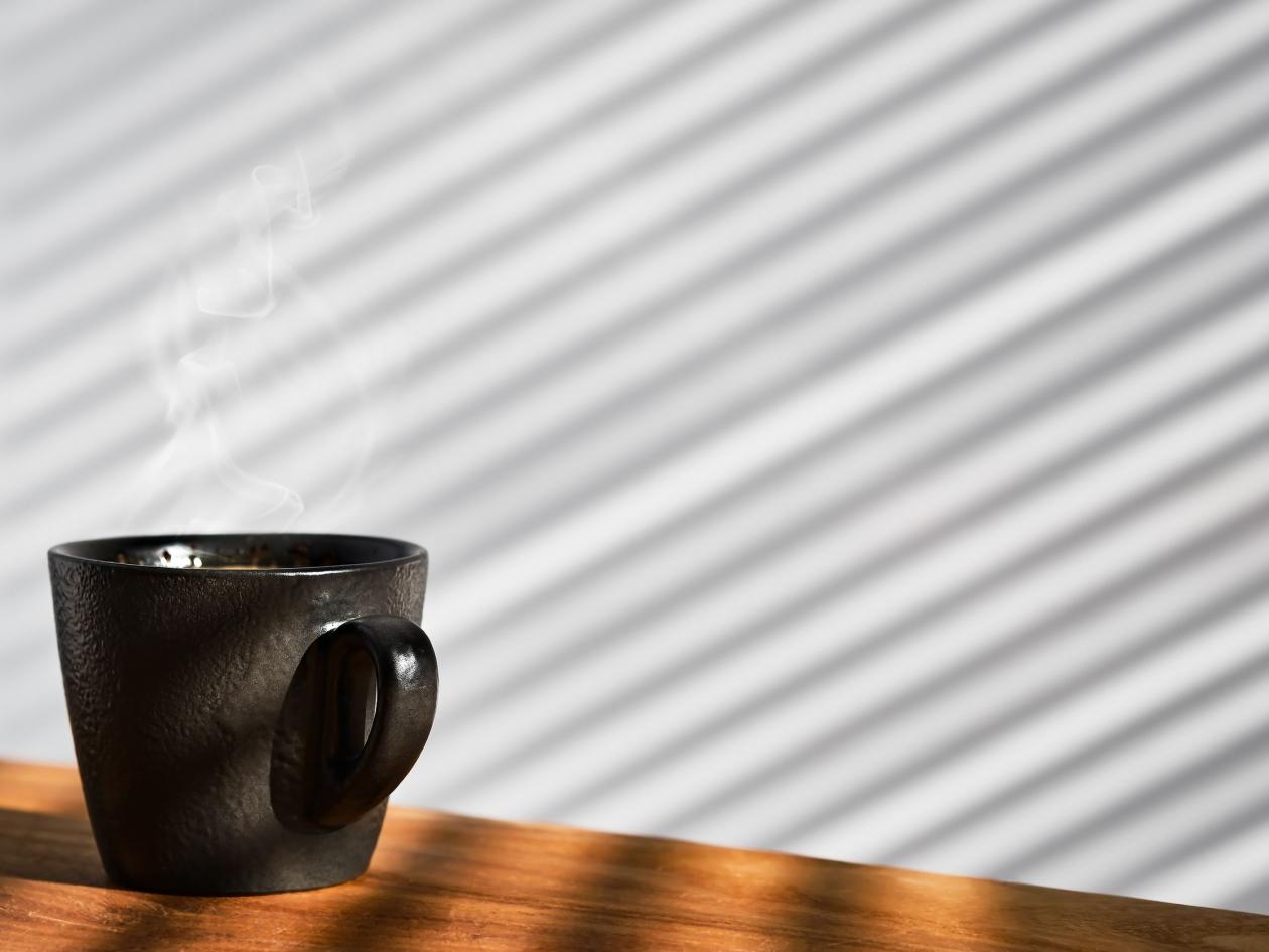 Cup Of Freshly Made Espresso Coffee In A Cup On A Wooden Table, Steam Rises Over The Ristretto. Coff