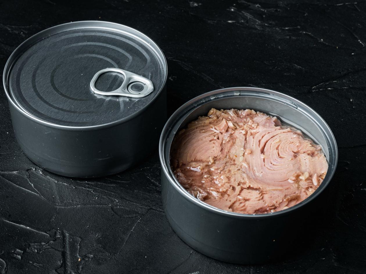 Canned Wild Yellowfin Tuna Set, In Tin Can, On Black Background