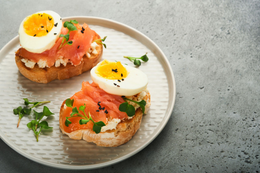 Sandwich With Delicious Toppings Smoked Salmon, Eggs, Herbs And Microgreens Radish, Black Sesame See