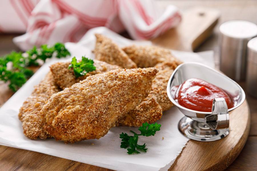 Chicken Nuggets Baked In Breadcrumbs With Ketchup, Closeup